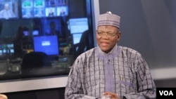 Jigawa State Governor Sule Lamido (R) waits on set for interview to begin.
