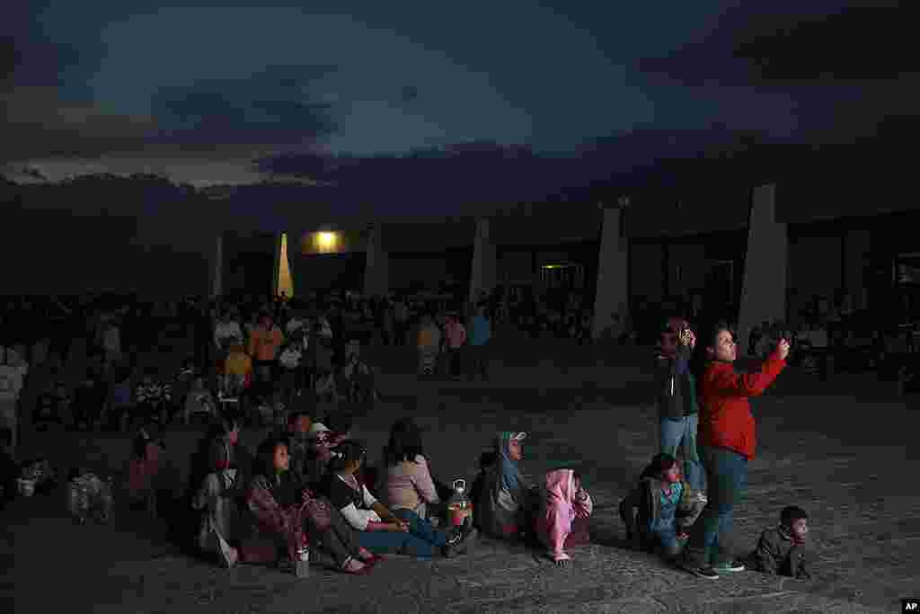 Faithful watch live coverage of Pope Benedict on a giant TV screen as they wait for the new lights of the Christ King statue to be inaugurated remotely by the pope, at the Cubilete Hill near Silao, Mexico, March 25, 2012. (AP)