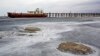 FILE - An abandoned ship is stuck in solidified salt at Lake Urmia, northwestern Iran. Once one of the biggest saltwater lakes on Earth, Urmia has been decimated by climate change, irrigation use and damming of nearby rivers.