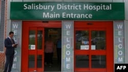 FILE - A general view shows the main entrance to Salisbury District Hospital, in Salisbury, England, July 04, 2018, where a British woman, Dawn Sturgess, poisoned with a nerve agent, died. Her partner, Charlie Rowley, who was also exposed, says he may soon die.