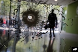 A bullet hole is pictured on a shop window on the Champs Elysees boulevard in Paris, April 21, 2017.
