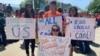 Protesters are seen in front of the U.S. Supreme Court in Washington as justices hear arguments on a citizenship question the Trump administration wants to add to the census questionnaire, April 23, 2019. 
