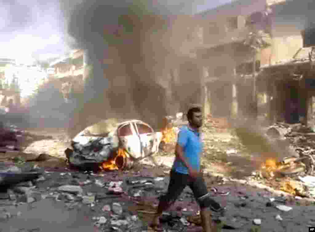 This image made from citizen journalist video posted by the Shaam News Network shows the aftermath of a car bomb attack on a market in the town of Darkoush in Idlib province, Oct. 14, 2013.