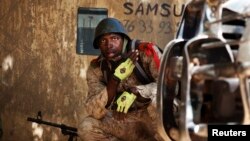 A Malian soldier looks on during fighting with Islamists in Gao, Feb. 21, 2013.