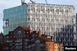 FILE - The new U.S. Embassy catches the evening light as it nears completion, in Nine Elms, London, Oct. 20, 2017.