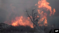 This Feb. 18, 2018 photo taken by the Bishop California Highway Patrol and released by the Inyo County Sheriff's Office shows smoke rising from wildfires near Bishop, California.