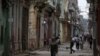 FILE - People walk on a street in Havana, Cuba, April 10, 2019. 