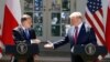 President Donald Trump and Polish President Andrzej Duda reach to shake hands at a news conference in the Rose Garden of the White House, in Washington, June 12, 2019. 