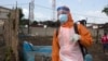 FILE - A health worker prepares to disinfect a van used for burial purposes in Freetown, Sierra Leone.