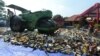 Sebuah mesin menghancurkan botol-botol minuman beralkohol dan DVD porno dan bajakan. (Foto: Dok)