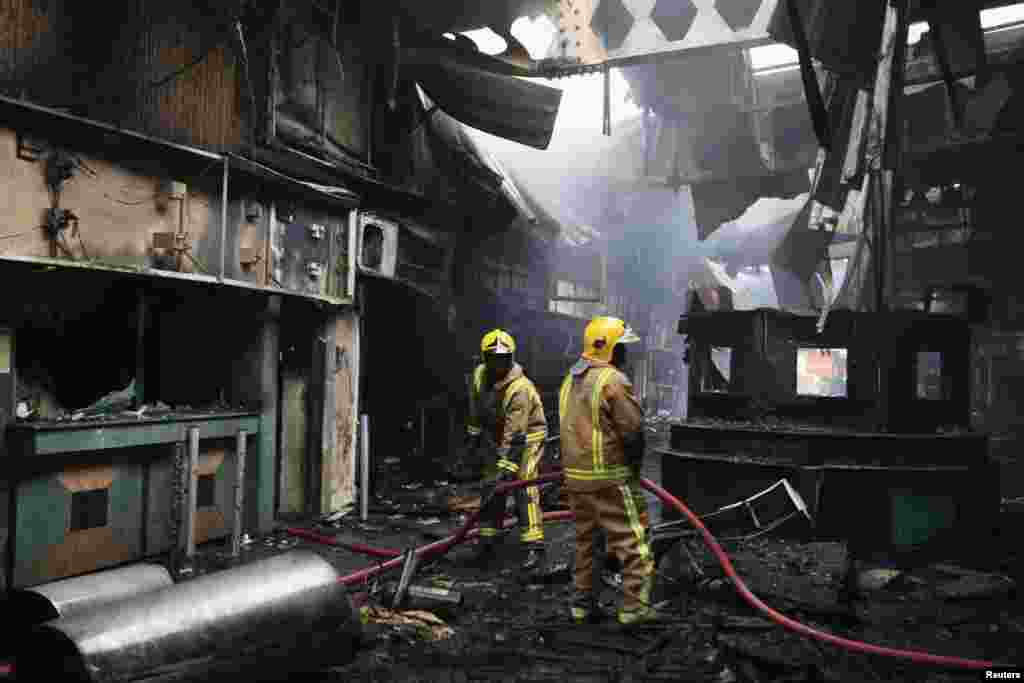 Firefighters struggle to put out a fire at the Jomo Kenyatta International Airport in Kenya's capital Nairobi, August 7, 2013.