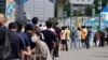 7일 한국 서울의 신종 코로나바이러스 감염 검사소에서 검사를 받기 위해 줄 선 시민들.