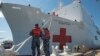 Boatswain's Mate 3rd Class Taryn Armington and Sonar Technician (Surface) Seaman Darian Joseph prepare to cast off mooring lines for the Military Sealift Command hospital ship USNS Comfort.