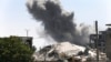 FILE - Black smoke rises from a coalition airstrike which attacked an Islamic State militant position, on the front line on the eastern side of Raqqa, Syria, July 26, 2017.