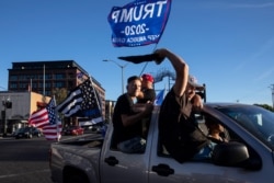 Supporters of President Donald Trump attend a rally and car parade Saturday, Aug. 29, 2020, in Clackamas, Ore., on the way to Portland.
