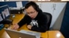FILE - Chinese journalist Li Xin talks to an Associated Press reporter over Skype, at the AP office in New Delhi, India, Nov. 20, 2015.
