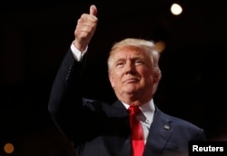 FILE - Republican presidential nominee Donald Trump, pictured at his party's convention, July 21, 2016, in reference to shootings at a Florida gay nightclub, pledged “to protect our LGBTQ citizens from the violence and oppression of a hateful foreign ideology.”