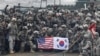 FILE - U.S. and South Korean army soldiers pose on a floating bridge on the Hantan River during a joint military exercise against a possible attack from North Korea, in Yeoncheon, South Korea, Dec. 10, 2015. 