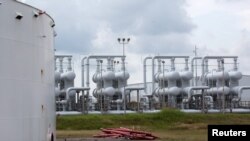 An oil storage tank and crude oil pipeline equipment is seen during a tour by the Department of Energy at the Strategic Petroleum Reserve in Freeport, Texas, U.S., June 9, 2016.