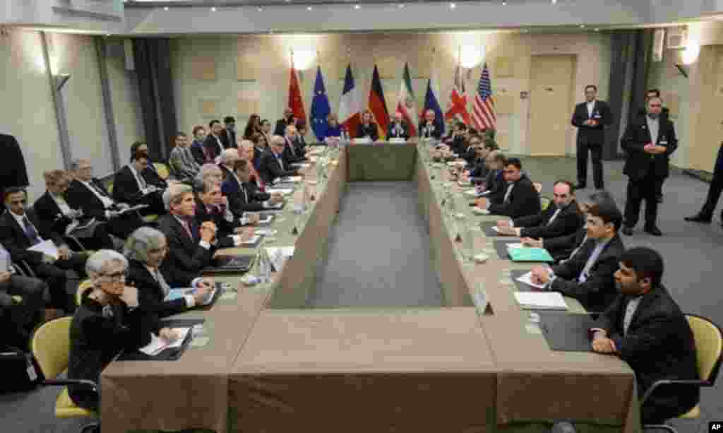 Officials of Britain, Russia, China, France, Germany, European Union, the United States and Iran wait for the start of a meeting on Iran's nuclear program at the Beau Rivage Palace Hotel in Lausanne, Switzerland, March 30, 2015.