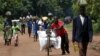 FILE - A Malawian man transports food aid distributed by the United Nations World Food Progamme (WFP) through maize fields in Mzumazi village near the capital Lilongwe, Feb. 3, 2016.