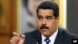 FILE - Venezuelan President Nicolas Maduro speaks during a news conference at Miraflores Presidential Palace in Caracas, Dec. 30, 2014.