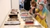 Пошкоджені книжки харківської типографії "Фактор-Друк", яка була зруйнована внаслідок російських обстрілів 23 травня 2024 року. Книги виставили для відвідувачів форуму "Книжковий Арсенал" у Києві. Фото: Anatolii Stepanov/AFP