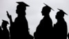 FILE - New graduates line up before the start of the Bergen Community College commencement at MetLife Stadium in East Rutherford, N.J., May 17, 2018.