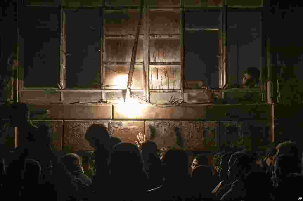 People wait in line to buy bread at a bakery in Aleppo, Syria, December 9, 2012.