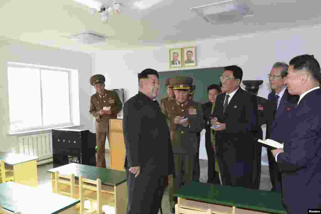 North Korean leader Kim Jong Un gives field guidance inside the Wisong Scientists Residential District complex in this undated photo released by North Korea's Korean Central News Agency (KCNA) in Pyongyang October 14, 2014.
