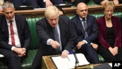 FILE - Britain's Prime Minister Boris Johnson speaks to lawmakers inside the House of Commons to update details of his new Brexit deal with EU, in London, Oct. 19, 2019.