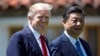 FILE - President Donald Trump and Chinese President Xi Jinping walk together after their meetings at Mar-a-Lago, April 7, 2017, in Palm Beach, Florida.