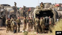 Israeli army soldiers deploy at a position near the border with Gaza in southern Israel on October 11, 2023.