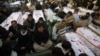 Shi'ite Muslims display the unburied coffins of victims of Thursday's twin bomb attack during a sit-in in Quetta, January 12, 2013.