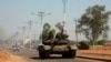 A military tank patrols along one of the main roads in the South Sudanese capital Juba, Dec. 16, 2013. The South Sudanese president declared a curfew in the capital Juba on Monday after clashes overnight between rival factions of soldiers.
