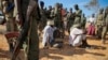 Alleged members of al-Shabab are blindfolded and guarded by soldiers of the Somali National Army (SNA) in Kismayo, southern Somalia, Wednesday, Oct. 3, 2012.
