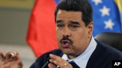 Venezuelan President Nicolas Maduro gestures during a news conference at Miraflores presidential palace in Caracas, Venezuela, Aug. 24, 2015.