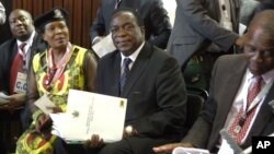 FILE: Emmerson Mnangagwa, center, and Saviour Kasukuwere (far left) seen at ZANU-PF headquarters in Harare, Zimbabwe, Dec, 10, 2014. 