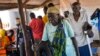 Kassa Wani and her husband, Alfred, from South Sudan, wait to register with U.N. officials as they arrive at the Busia, South Sudan processing center, March 29, 2017