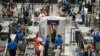 FILE - Travelers wear face coverings in the line for the south security checkpoint in the main terminal of Denver International Airport on Aug. 24, 2021, in Denver.