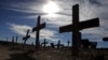 Crosses fill a graveyard in Cape Town's Khayelitsha township February 27, 2010. Many of those buried in the South African cemetery died from AIDS or related complications such as tuberculosis (TB).