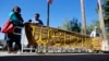 FILE - Supporters place a sign welcoming Syrian refugees at the entrance to the Arizona governor's office during a rally at the Capitol in Phoenix, Nov. 17, 2015.