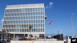 FILE - In this Aug. 14, 2015, file photo, a U.S. flag flies at the U.S. embassy in Havana, Cuba. U.S. investigators are chasing many theories about what’s harming American diplomats in Cuba, including a sonic attack, electromagnetic weapon or flawed spying device. 