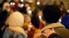 FILE - Community members gather during a candlelit vigil in support of legislation for child victims of human trafficking, Dec. 11, 2014, in Atlanta. 