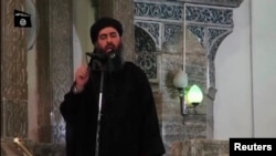 Smage taken from recently released video shows man purported to be Abu Bakr al-Baghdadi, ISIL's reclusive leader, making what would be his first public appearance at a mosque in the centre of Iraq's second city, Mosul July 5, 2014.