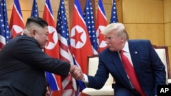 FILE - U.S. President Donald Trump and North Korean leader Kim Jong Un meet in the Demilitarized Zone, South Korea, June 30, 2019. North Korea on Friday says it wants Trump to make a "wise option and bold decision" to restart stalled nuclear diplomacy.