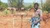 Woman at water tap