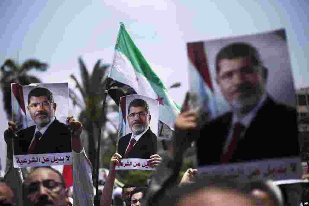 Supporters hold posters of Egypt's Islamist President Mohamed Morsi during a rally near Cairo University Square in Giza, July 2, 2013.