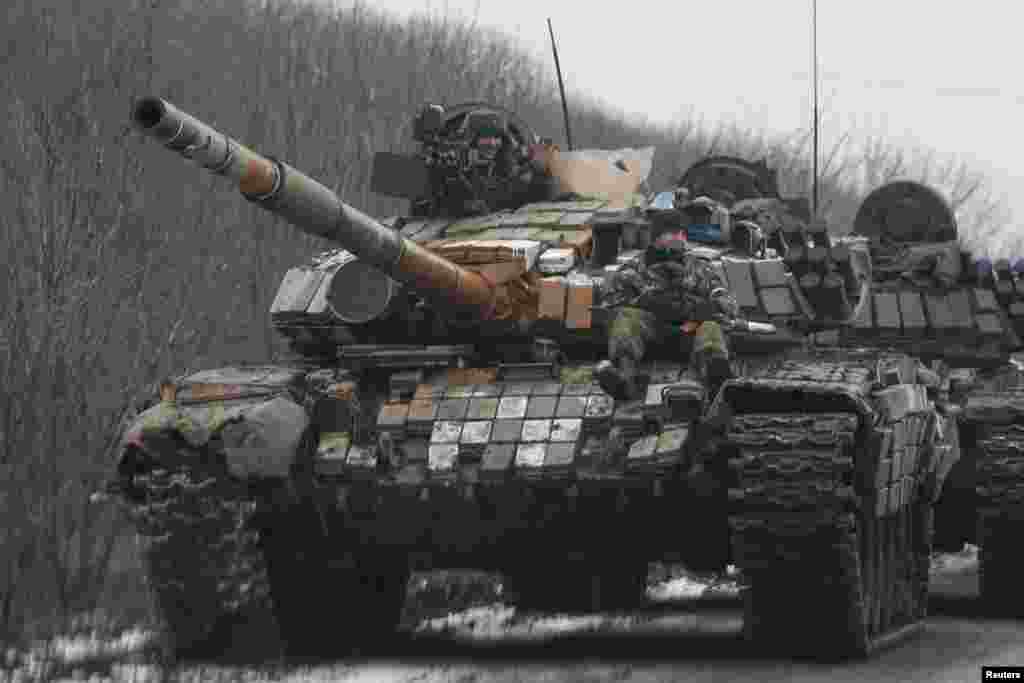 Members of the armed forces of the self-proclaimed Donetsk People's Republic ride on a tank in Vuhlehirsk, Donetsk region, Feb. 6, 2015. 