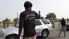 FILE - Chadian customs officers control traffic on the N'Gueli bridge, marking the border between Chad and Cameroon near N'Djamena, April 4, 2015. Traders and truck drivers took to the bridge Dec. 16, 2020, to protest COVID-imposed travel restrictions.